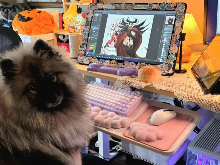 Frida's dog beside her pink-lit digital art workspace